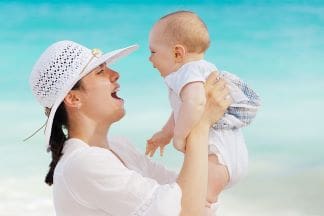 A Fit and healthy lifestyle mother holding her baby