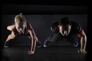 A fit and healthy lifestyle man and woman doing pushups