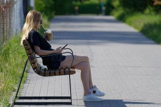 A fit and healthylifestyle woman taking a brake on a park bench