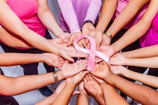 A fit and healthy lifestyle hands in a circle holding a oink ribbon