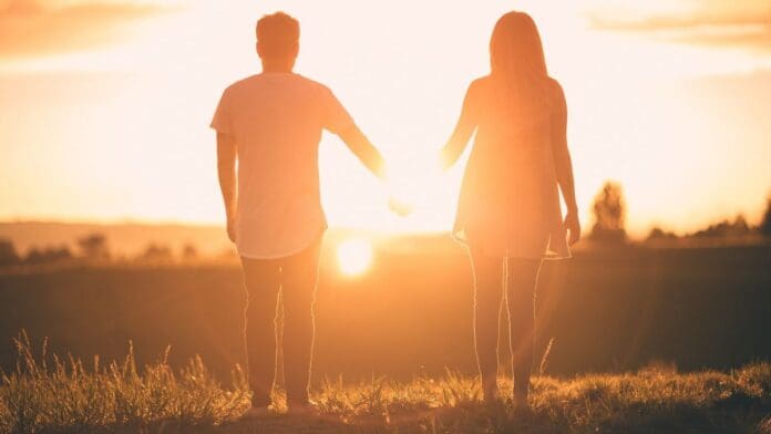 A Fit and Healthy Lifestyle Couple holding hands in the sunshine