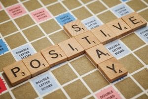 Stay Positive spelled out in tiles Scrabble 