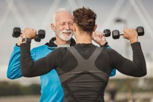 Motivational Supplements 2 men lifting light weight together