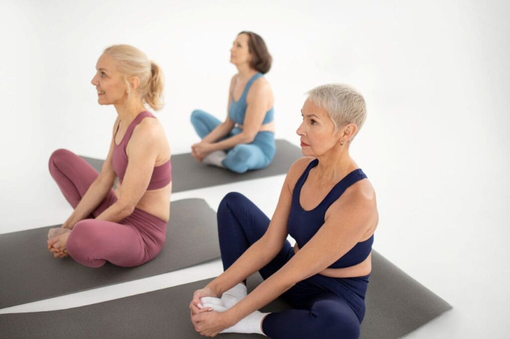 Picture of three older women doing yoga.
