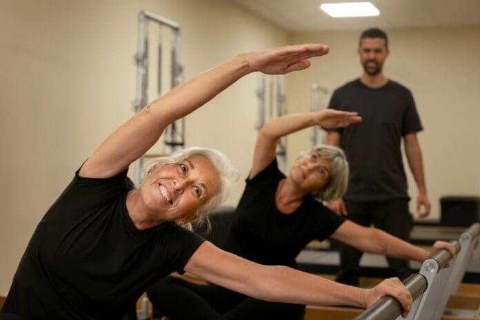 Picture of a women on a Pilates machine.