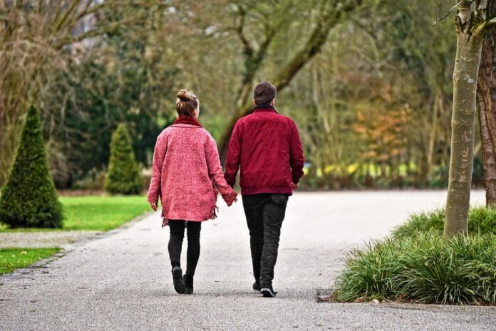 Picture of a couple walking in the park.