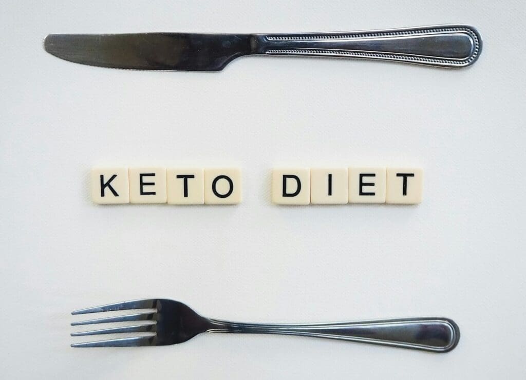 Picture of scrabble tiles that spell Keto. Keto Diet Pros and Cons, weight loss