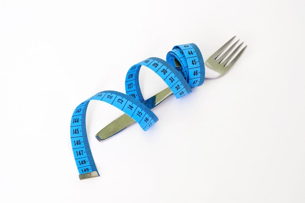 Picture of a fork wrapped in a tape measure. General Nutrition Versus Personalized Nutrition, a balanced diet, maintain health
