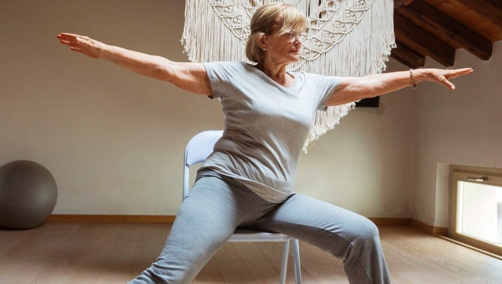 Picture of a woman doing chair yoga. Best Exercises for People Over 65