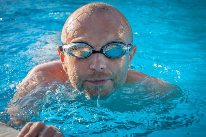 Picture of a man swimming. Benefits of Swimming for Exercise: 