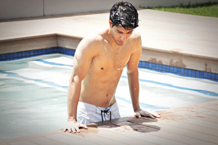 Picture of a Fit and Healthy man getting out o a pool. Motivation to Live a Fit and Healthy Lifestyle