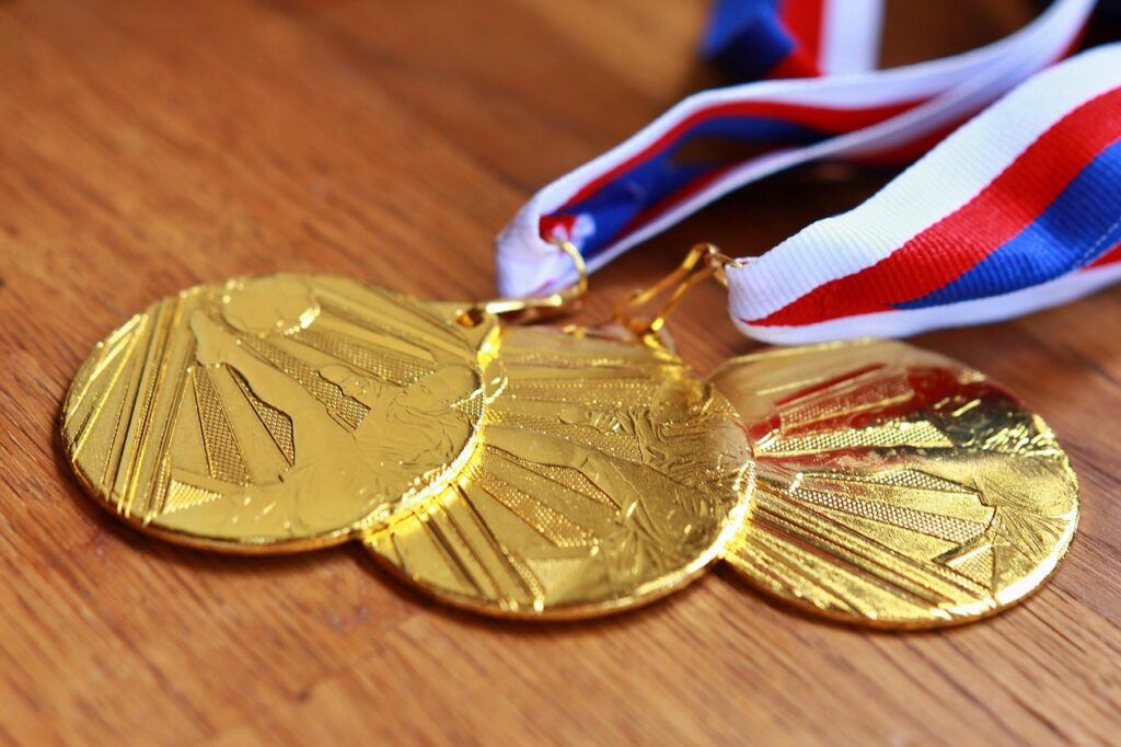 Picture of gold medals. Foster Innovation and Creativity, empower individuals, Encouraging risk taking,