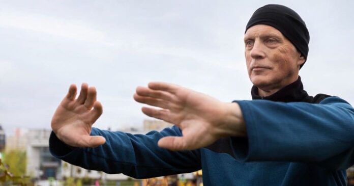Picture of a man doing Tai Chi outdoors. Benefits of Tai Chi