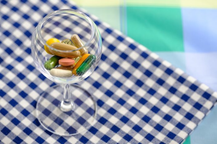 Picture of a glass full of supplements. Water Soluble and Fat Soluble Vitamins