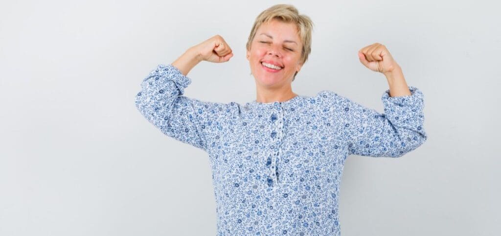 Picture of an older woman flexing her muscles. Daily Multivitamins for Women Over 60