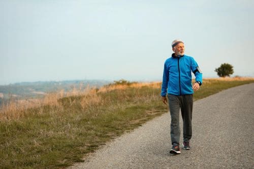 Older man out walking. A low impact aerobic exercises.
