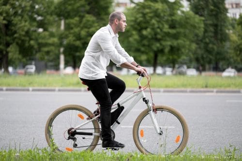 Older man riding a bike.